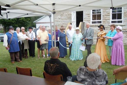 Members of South Frontenac Council and staff along with members of Portland District and Area Heritage Society cut the ribbon at the official opening of the South Frontenac Museum in Hartington